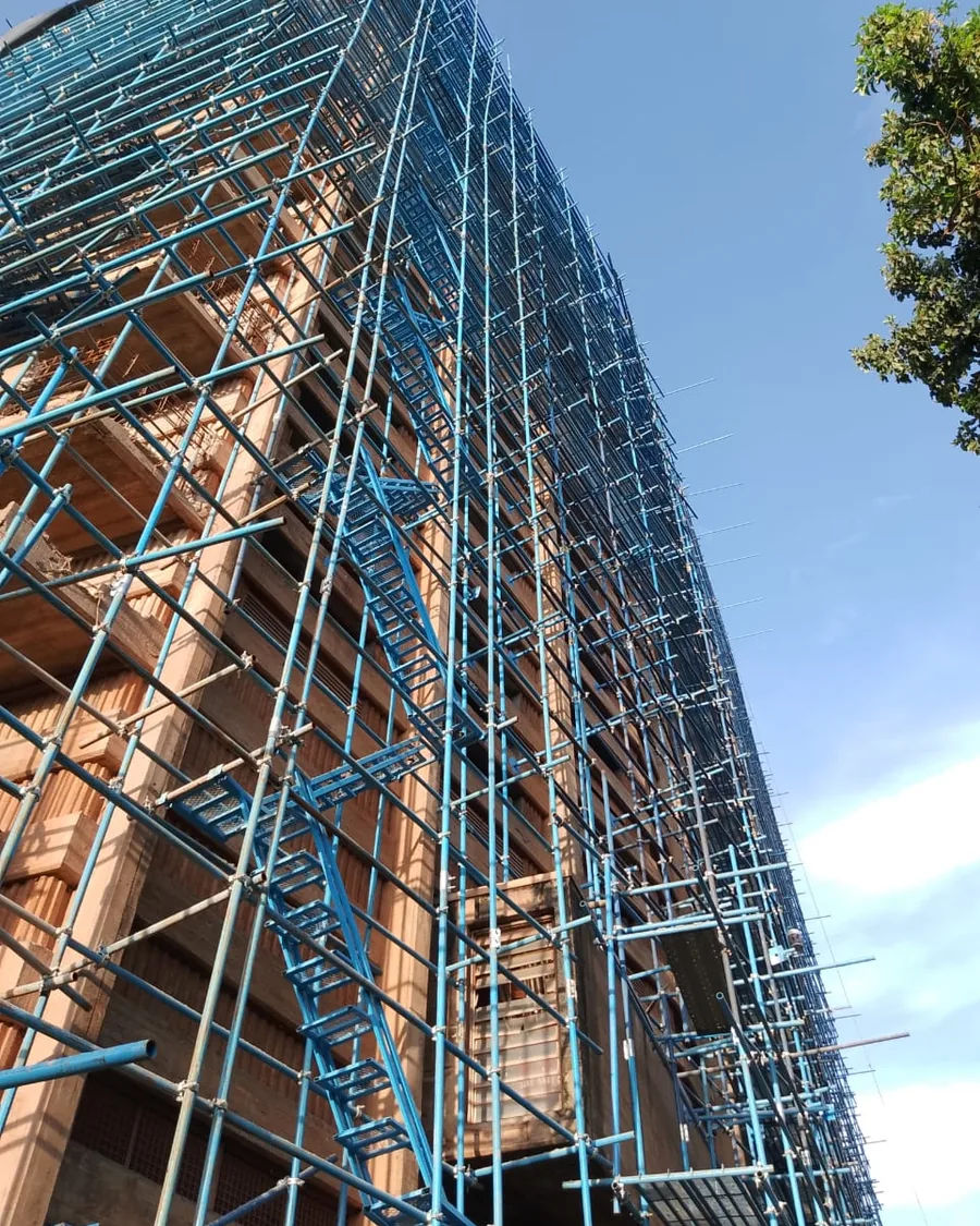 Multi-storey Tetrabuild project fully wrapped in scaffolding, Kampala