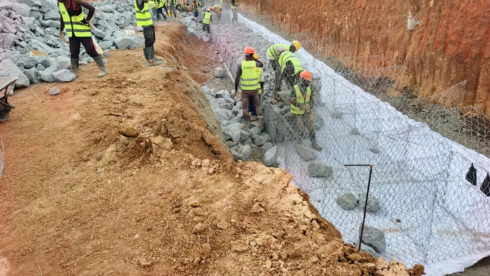 Tetrabuild crew building a gabion retaining structure on site