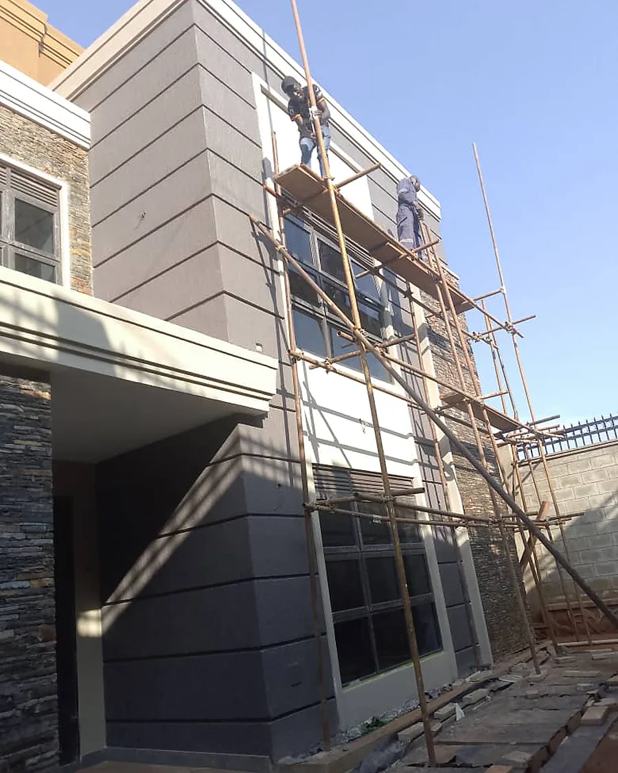 Tetrabuild crew finishing the façade of a completed residence in Kampala