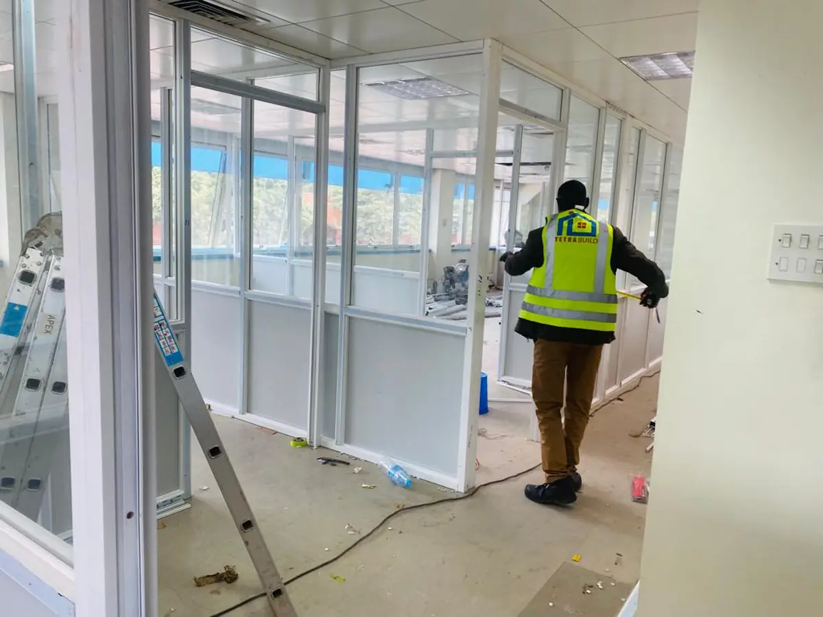 Aluminium framed partitions and glazing being installed inside a completed interior