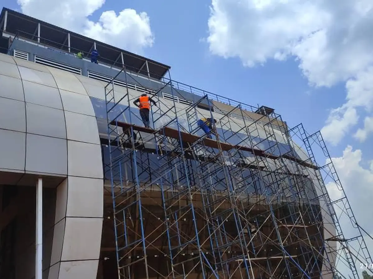Scaffolding erected against an aluminium-clad façade at the Kiira EV Motor Corporation plant