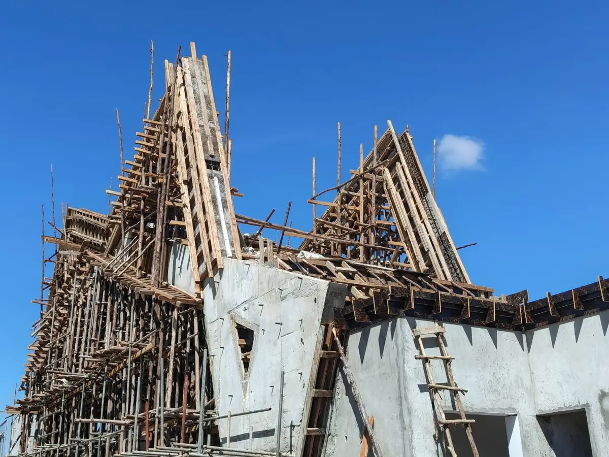 Timber formwork and falsework shaping the Soroti University entrance gate structure